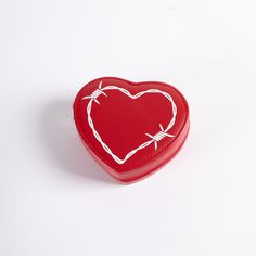 a red heart shaped box with barbed wire on the inside and white outline around it