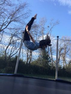 a person doing a trick on a trampoline