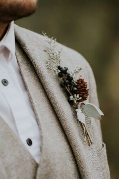 a man in a suit with a boutonniere on his lapel