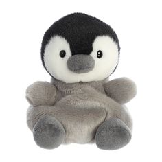 a stuffed penguin is sitting on its back