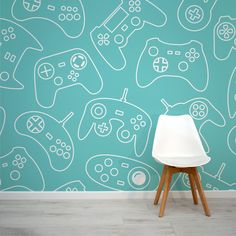 a white chair sitting in front of a wall with video game controllers drawn on it