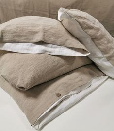 two linen pillows stacked on top of each other