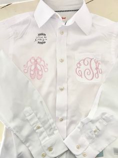 "A ballet coverup for your little ballerina is perfect when getting ready for that big stage moment. This recital coverup is so cute while waiting to dance on stage or for that long gymnastics/cheer competition weekend.   This is for a white button up shirt with a 3 letter monogram and ballet shoes design. We can change the design based on your preference. I have other dancer designs and gymnasts to.  White long sleeve button up Typically best to size up for a more \"oversized fit\" Toddler size Fitted Tops For Cheerleading In Spring, Pink Fitted Top For Cheerleading, White Fitted Top For Dance Class, Pink Stretch Tops For Dance, Fitted Preppy Tops For School, Fitted Cotton Shirt For Dance, White Cotton Dance Tops, Fitted Preppy White Shirt, White Fitted Preppy Shirt