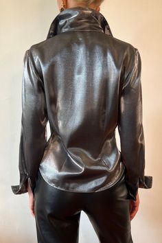 Metallic Shiny Chic Tops, Chic Metallic Shiny Tops, Chic Shiny Tops For Fall, Chic Metallic Shine Tops, Chic Metallic Tops With Shine Detail, Glamorous Fitted Shiny Blouse, Metallic Sheen Tops For Fall, Elegant Fitted Silver Top, Chic Shiny Long Sleeve Tops