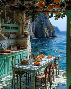 an outdoor kitchen with oranges on the table and blue water in the back ground