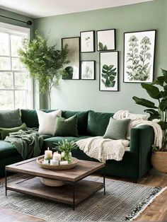 a living room with green couches and pictures hanging on the wall above the coffee table