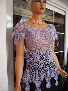 a mannequin wearing a purple crochet top