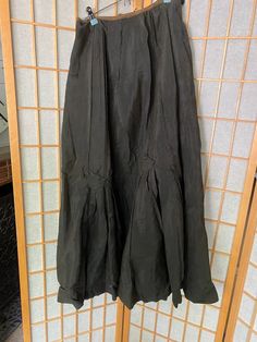 Very cool antique silk skirt with button details. In fair condition, several holes and rips, see all photos! Unfinished waist closureWaist: 27-29”Waist to hem: 30” Black Pleated Silk Skirt, Black Silk Flared Skirt, Black Vintage Ruffled Skirt, Black Silk Pleated Skirt Bottoms, Fitted Black Silk Maxi Skirt, Fitted Silk Black Maxi Skirt, Black Silk Bottoms With Pleated Skirt, Vintage Silk Long Skirt, Black Vintage Tiered Skirt