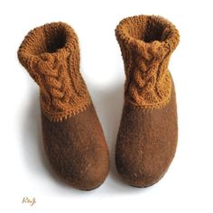 a pair of brown slippers sitting on top of a white floor