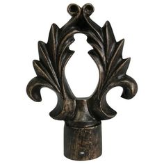 an ornate metal object with leaves on it's head and two holes in the center