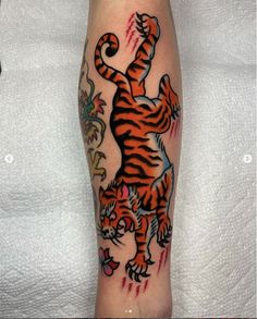 a man with a tiger tattoo on his leg