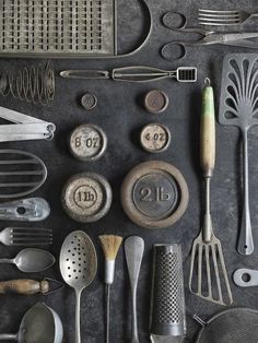 an assortment of kitchen utensils are displayed on a table