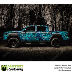 a blue pickup truck parked in the dark with trees behind it and clouds above its head