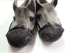 a pair of slippers made to look like horses are sitting on a white surface