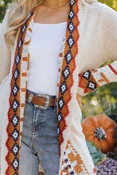 Our Beige Tribal Print Fringe Duster Cardigan is perfect for any fall occasion! This duster-length cardigan showcases a bold tribal print and a fringe hem for added style. It offers both comfort and a touch of bohemian flair, making it perfect for layering throughout the season. Layer it over a basic top and pair with jeans, ankle booties, and matching accessories to complete the look. Beige Bohemian Cardigan For Fall, Bohemian Beige Cardigan For Fall, Bohemian Fair Isle Pattern Cardigan For Fall, Bohemian Fall Festival Cardigan, Bohemian Fall Cardigan With Tassels, Bohemian Fair Isle Cardigan For Fall, Spring Beige Fringe Cardigan, Spring Fringe Long Sleeve Cardigan, Bohemian V-neck Cardigan For Layering