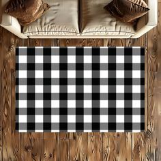 a black and white checkered rug on a wooden floor