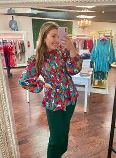 Look as pretty as a flower in the beautiful Flower Power baby doll top! With a smocked bodice and a frilled mock-neck, you'll be the envy of all your friends. The layered ruffle shoulders and long bubble sleeves make for a fashionable floral look that will leave you feeling like you just bloomed! (No green thumb required!) 100% polyester and lightweight. Sizing: runs true to size; size chart included in the photos Spring Flowy Smocked Top For Brunch, Feminine Floral Smocked Top For Fall, Feminine Fall Smocked Top With Floral Print, Playful Ruffle Sleeve Tops For Spring, Spring Day Out Smocked Top With Ruffles, Spring Smocked Top With Ruffles For Day Out, Playful Floral Print Blouse For Spring, Fall Fitted Smocked Top With Ruffles, Fitted Smocked Top With Ruffles For Fall