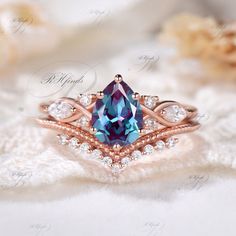 a ring with a blue topazte surrounded by white and rose gold diamond accents