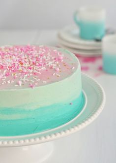 a cake with sprinkles on it sitting on top of a table