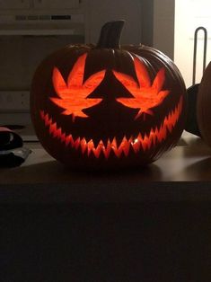 two carved pumpkins sitting on top of a counter