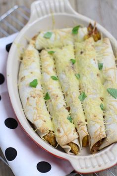 a dish filled with some taco shells on top of a polka dot table cloth