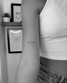 a woman's arm with the words why not written on it, in black and white