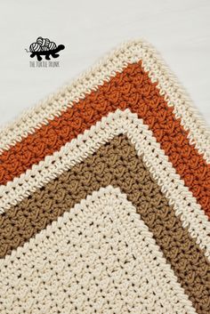 the crocheted afghan is made up of two different colors and has an interesting design