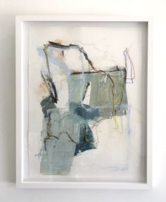 an abstract painting in a white frame hanging on a wall