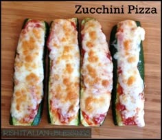 four zucchini pizzas sitting on top of a wooden cutting board