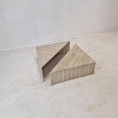 two pieces of wood sitting on top of a white floor