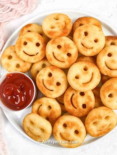 a white plate topped with fried pastries and ketchup