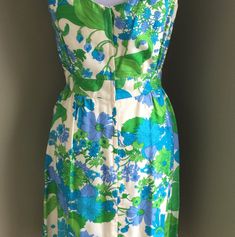 "Eye catching floral sleeveless dress by Peck and Peck of Fifth Avenue New York. This 1950's dress has a cotton lining and is in great condition with one small spot on bow. Please view pictures. This well made dress is prefect for any event this summer. Colors are turquoise, periwinkle, lime green and white. This would be considered a Small. The fabric is woven and does not stretch. Additional Details content: Rayon, Cotton lining. * Note: metal zipper has been replaced with plastic zipper. Meas Vintage Sleeveless Dress For Garden Party, Sleeveless Dresses For Spring Vintage Fashion, 1950s Style Floral Print Dress For Vintage Fashion, Retro Sleeveless Vintage Dress For Garden Party, Sleeveless Vintage Dress For Garden Party, Vintage Lined Dresses For Garden Party, Vintage Lined Dress For Garden Party, 1950s Style Lined Dress For Garden Party, Spring Mid-century Dresses For Vintage Events