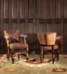 two brown chairs sitting next to each other on top of a rug