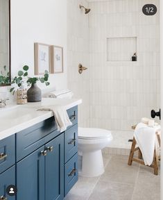 a white toilet sitting next to a bath tub in a bathroom on top of a tiled floor