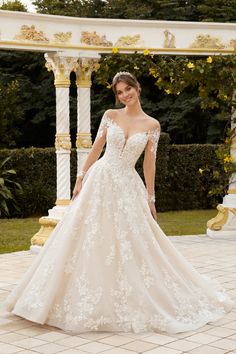 a woman in a wedding dress posing for the camera