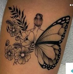 a black and white photo of a butterfly with flowers on it's back leg