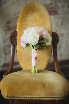 a bouquet of flowers sitting on top of an old chair