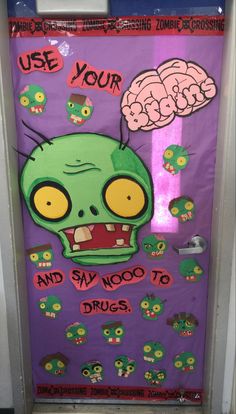 a door decorated with an image of a green monster and brain on it's side