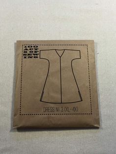 a brown paper bag with a sewing pattern on the front and side of it that says dress no 3 xx - xx