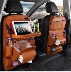 the back seats of a car are filled with bottles and other items, including an ipad