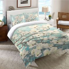 a bed with blue and white flowers on it