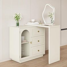 a white desk with drawers and a mirror on it's shelf next to a wall