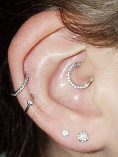 an ear with three piercings attached to it