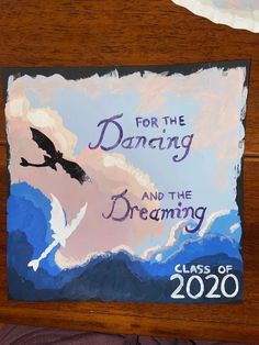 a sign that reads for the dancing and the dreaming class of 2020 with a painting of a flying bird