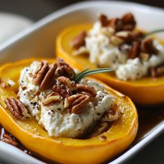 stuffed squash with mashed potatoes and pecans in a white casserole dish