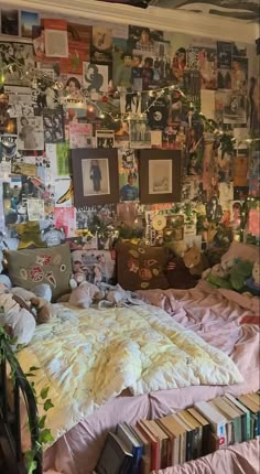 an unmade bed with lots of books on the wall and pictures all over it