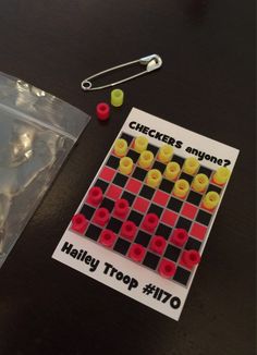 a checker's answer game next to a bag of gummy bears on a table