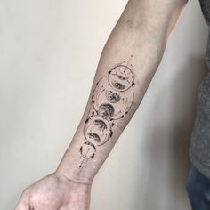 a man's arm with phases of the moon and stars tattoo design on it