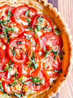 a tomato and basil quiche on a wooden table