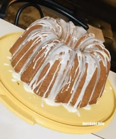 a bundt cake sitting on top of a yellow plate next to a white counter